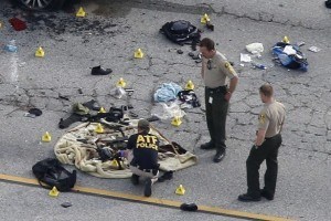 Law enforcement officers look over the evidence near the remains of a SUV involved in the Wednesdays attack is shown in San Bernardino, California December 3, 2015. Authorities on Thursday were working to determine why a man and a woman opened fire at a holiday party of his co-workers in Southern California, killing 14 people and wounding 17 in an attack that appeared to have been planned. REUTERS/Mario Anzuoni - RTX1X3LM